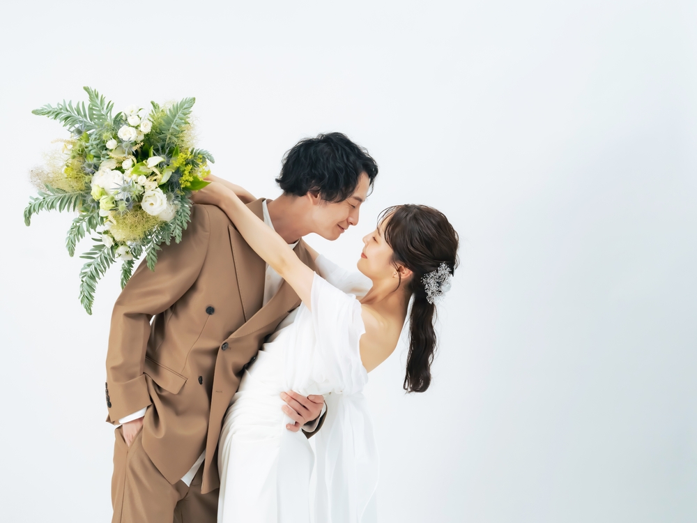 A bride and groom dressed for their wedding